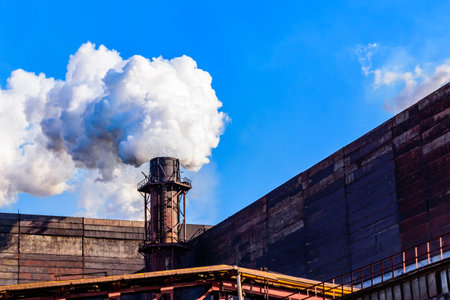 View on smoke pipe of factory against blue sky. Environmental pollutionの写真素材