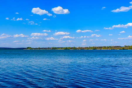 Summer landscape with green trees and lake. Kremenchug reservoirの写真素材