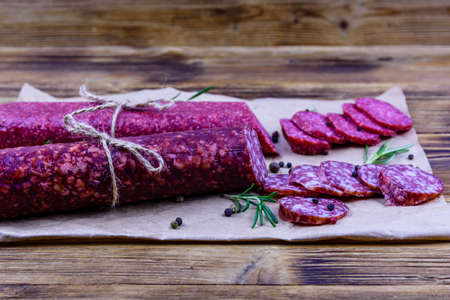 Dry smoked salami sausage on wooden backgroundの写真素材