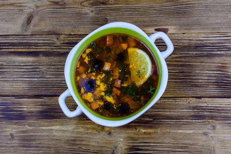 Russian traditional hodgepodge soup on wooden table. top viewの写真素材