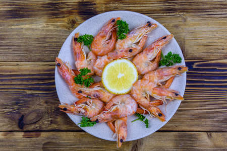 Shrimps with lemon and parsley on plate. top viewの写真素材