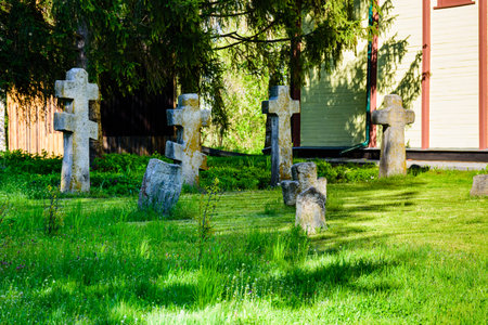 Old stone crosses at ancient cemetery. Abandoned graveyard