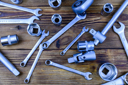Sockets wrench and spanners on wooden background. top view