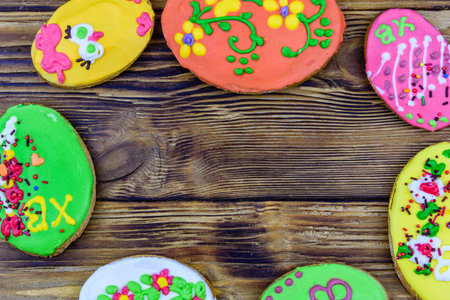 Easter cookies in plate on wooden background. top viewの写真素材