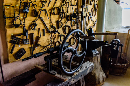 Old vintage hand tools hanging on wall at workshopの写真素材