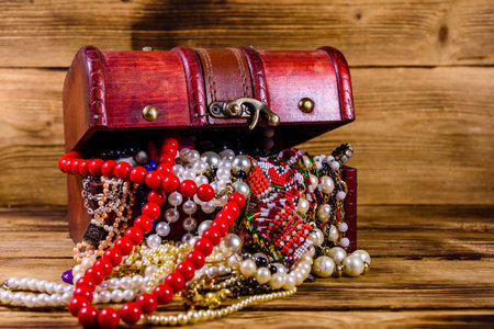 Old box of red wood full of jewelry. treasure chestの写真素材