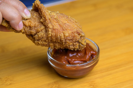 Hand holding crispy fried chicken. Fast foodの写真素材