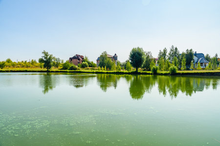 Houses on the bank of river Khorol in Myrhorod, Ukraine. summer landscapeの写真素材