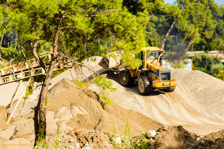 Heavy excavator working at limestone quarry. Mining industry