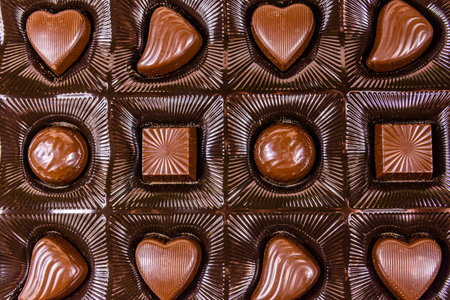 Heap of chocolate candies in brown box. Top viewの写真素材