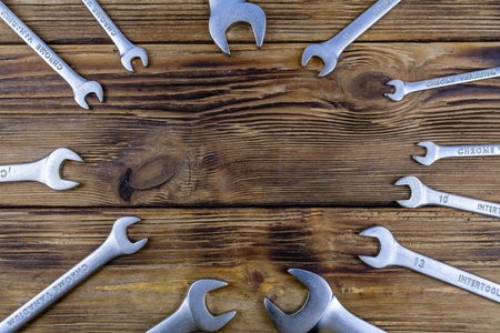 Set of spanners on the wooden background. Top viewの写真素材