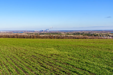 View on smoke pipes of factory and agricultural fieldの写真素材