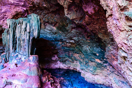 Stalactites and stalagmites in Kuza cave at Zanzibar, Tanzania. Natural pool with crystal clear waterの写真素材