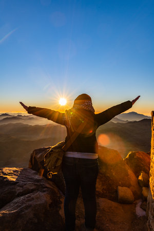 Young woman meets the dawn at the top of Mount Sinai. Sinai peninsula, Egyptの写真素材