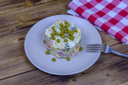 Ceramic plate with new year salad olivier on wooden tableの写真素材