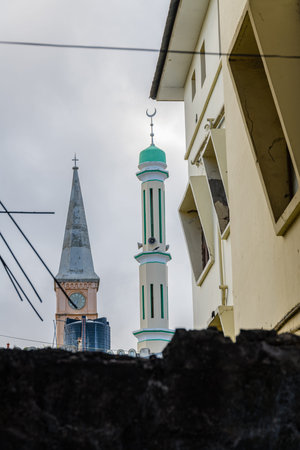 Minaret of Masjid Jibril (Gabriel mosque) and tower of Anglican cathedral in Stone town. Zanzibar,...