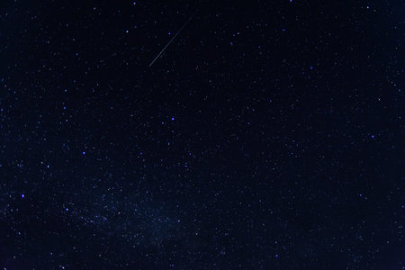 Background of night sky with many stars. Satellite trajectory