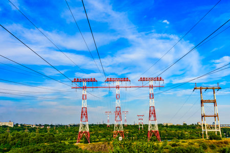 High voltage power lines across river Dnieper in Zaporozhye city, Ukraine. Three masts on island...