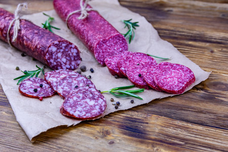 Dry smoked salami sausage on wooden backgroundの写真素材