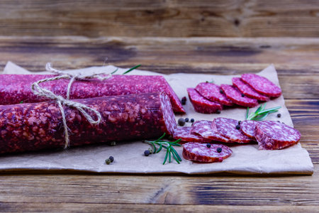 Dry smoked salami sausage on wooden backgroundの写真素材