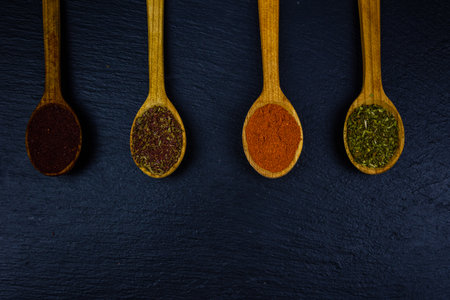 Spoons with oriental spices on slate board. Top viewの写真素材