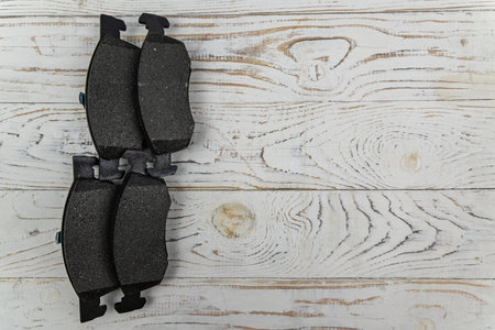 Disc brake shoes on white wooden background. Top viewの写真素材