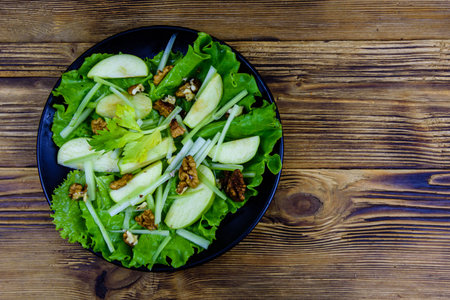 Plate with waldorf salad on wooden tableの写真素材