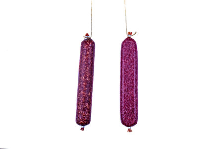 Dry smoked salami sausage isolated on white background