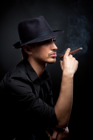 Gangster look. Man with hat and cigar. の写真素材