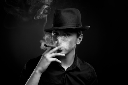 Man with hat and cigar in Black の写真素材