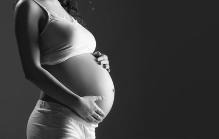 belly of pregnant woman monochrome on a dark backgroundの写真素材