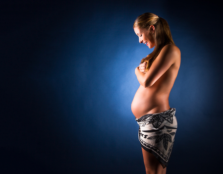 Pregnant woman caressing her belly. 28 weekの写真素材
