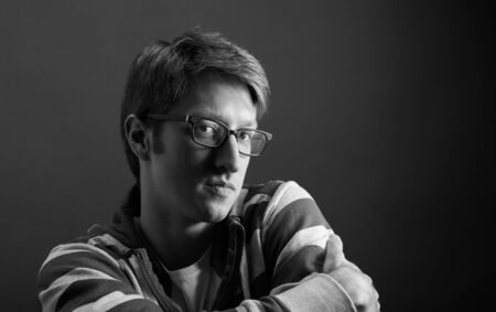 Young mans portrait. Close-up face against gray backgroundの写真素材