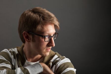 Young mans portrait. Close-up face against gray backgroundの写真素材