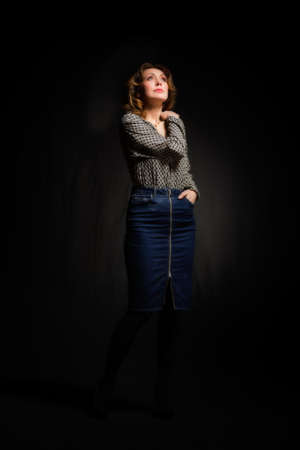 Low key fashion portrait of elegant woman over black backgroundの写真素材