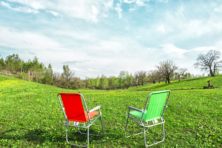 Camping on a green meadow in the forest in sunny summer dayの写真素材