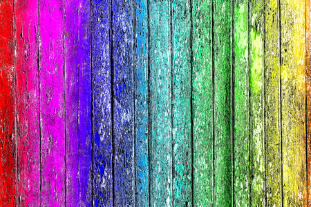 Old shabby wooden planks with cracked color paint, background old panels. Color-Peel wood texture. Multicolored fence.の写真素材