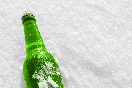 Bottle of cold beer on the snow. Close up view.の写真素材