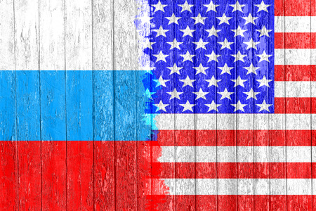 Flag of Russia and USA painted on the wooden board. Arms race and rivalry. The third world war. The conflict between Russia and America. Political concept. Front view.の写真素材
