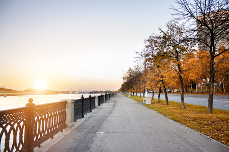 Embankment at sunset. Autumn city.の写真素材