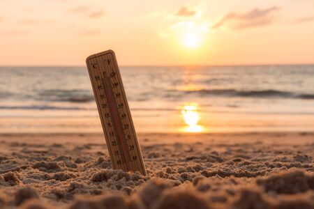 Close-up of thermometer on the sand showing high temperature.の写真素材