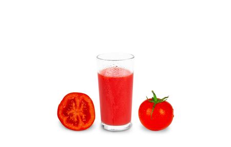 Misted glass of cold tomato juice and fresh ripe tomatoes covered droplets of water on white isolated background.の写真素材