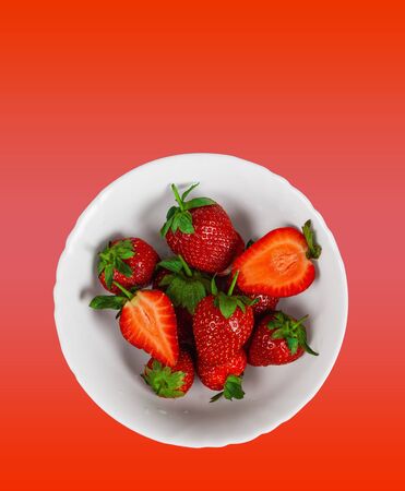 Juicy strawberries on a red background.の写真素材