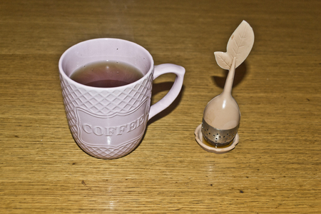 Cup of tea with tea strainerの写真素材