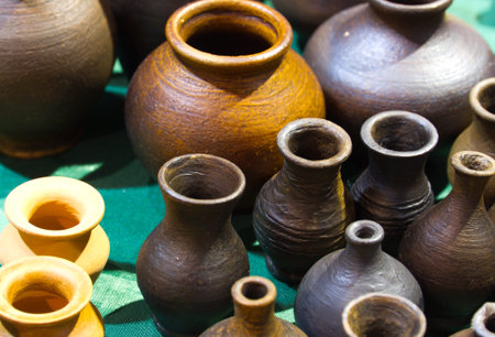 Handmade traditional russian ceramics (crockery, things, ware, jugs, pots) on the shopboard at the...