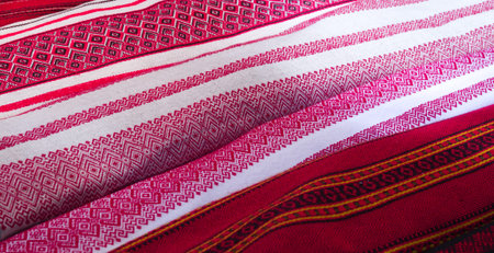 Stock of linen (flax) fabric rolls with traditional russian ornament design (red embroidery over...