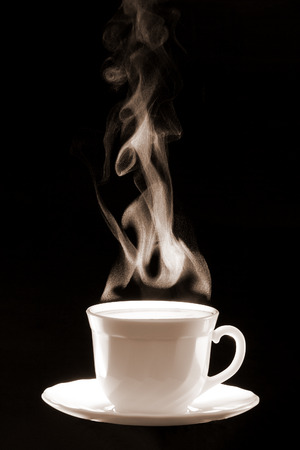 White cup coffee with steam consisted of little water  drops on a dark black background.の写真素材