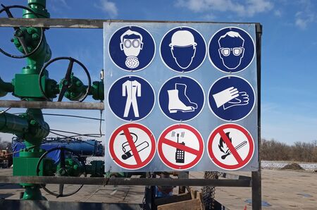 mandatory signs are on gas well fenceの写真素材