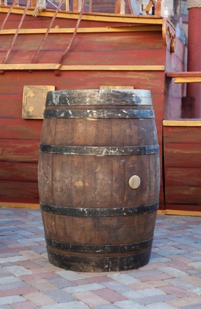 Old wooden barrel with part of ship on backgroundの写真素材