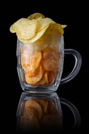 Beer snackes. Potatoes chips. Isolated on blackの写真素材